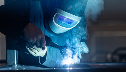 Man working on iron with grinder. Man at work. Sparkles and fire from grinder cutting. Grinder....