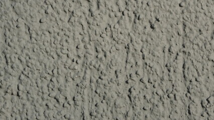 Rauhputz an Wand, Gebäudewand in grau, gestrichen als hintergrund für Bauunternehmen, Bau, Maurer, Fassade