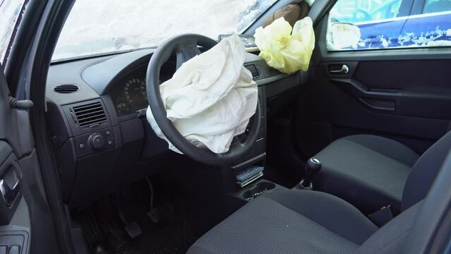 Deployed car airbags after a collision, car accident, vehicle security system after car crash. Deflated air bag