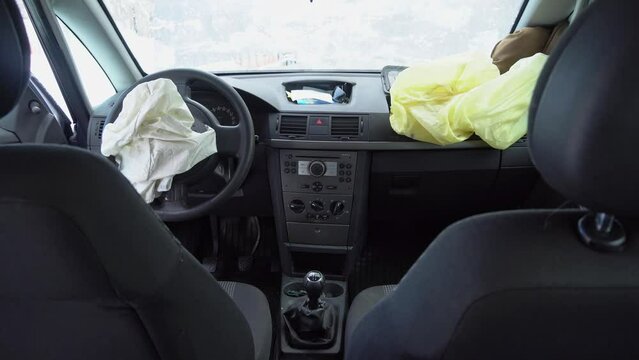 Deployed car airbags after a collision, car accident, vehicle security system after car crash. Deflated air bag