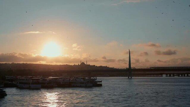 Sun is setting down 4K time lapse panorama clip with Halic metro bridge. Taken from Galata Tower, Istanbul, Turkey