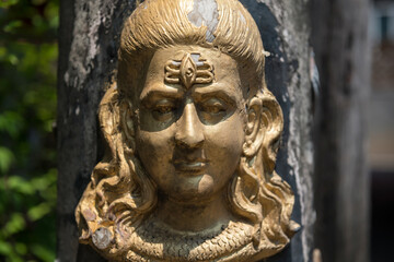 Hindu God golden Shiva Durga status attached on pillar