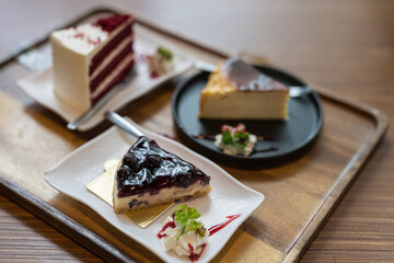 blueberry cheesecake with blur red velvet on wooden table