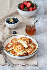 Cottage cheese pancakes with fresh berries. Tasty breakfast food
