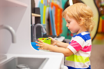 Child playing with colorful toys at the learning center or in kindergarten