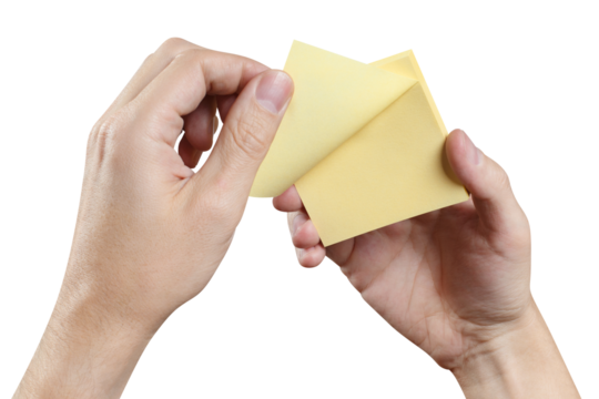 Hands holding stack of yellow stickers, cut out