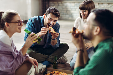  Young happy friends having fun while eating pizza