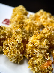 sushi and rolls on the white Japanese plate on black background