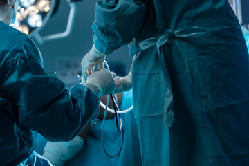 Close-up doctor's hands busy with knee surgery puncture, patient undergoing surgery, doctor's...