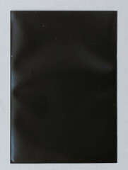 dark or black empty transparent plastic card sleeve on white paper background, gaming or trading card placeholder.
