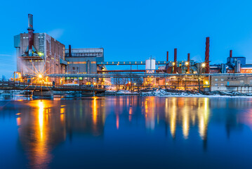 Fototapeta na wymiar Illuminated Factory Skyline at Dusk in Sweden
