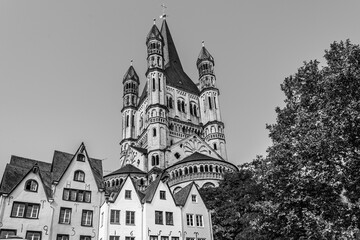 Obraz premium Cologne, North Rhine Westphalia, Germany: Great St. Martin church and old medieval houses in the old town of Cologne in black and white