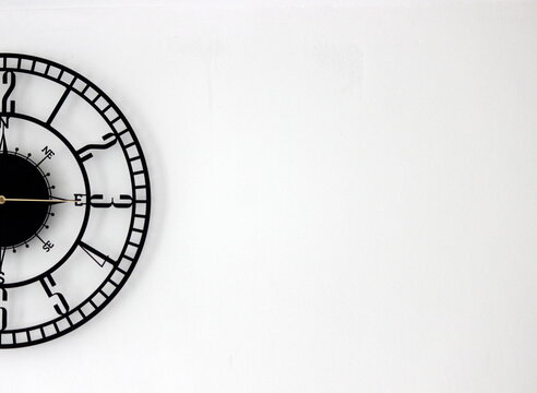 A half of the wall clock placed in the left side of the background to create a black and white poster, template or texture for marketing or sales in business or time related services 