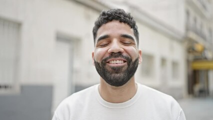 Young hispanic man smiling confident speaking at street - Powered by Adobe