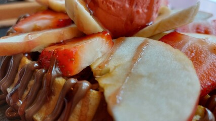 Ice cream with strawberries, bananas and chocolate photo of fruit plate close up.