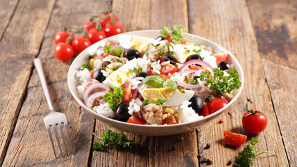 bowl of rice salad with egg, tuna, tomato and onion