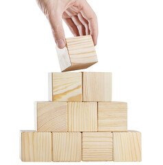 Hand putting a wooden cube on top of pyramid of cubes, cut out