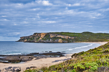 Coastal scenery: bay with deserted beach and high limestone cliffs. Cathedral Rock Beach, Windy...