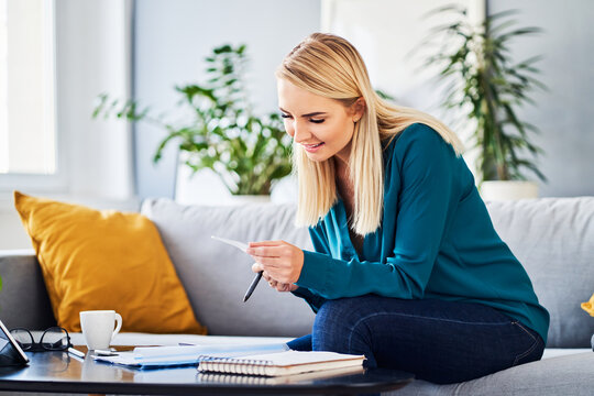 Young Woman Paying Bills Doing Accountant Work At Home