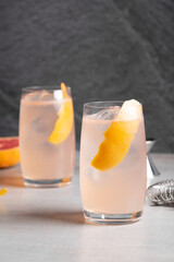 Homemade Paloma cocktail booze tequila, grapefruit juice, lime juice, syrup and club soda grapefruit peel as garnish