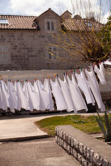Fresh clean white clothing hanging outside in wind and sun to dry. Laundry drying on the rope outside on a sunny day near the sea.