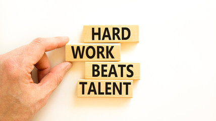 Hard work beats talent symbol. Concept words Hard work beats talent on wooden block. Beautiful white table white background. Motivational business hard work beats talent concept. Copy space.
