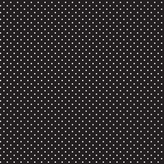 Seamless pattern in a small dot, polka dot style in white on a black background