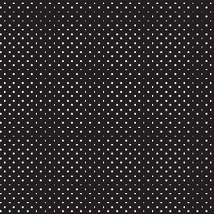 Seamless pattern in a small dot, polka dot style in white on a black background