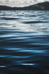 Vertical closeup of dark blue water texture at Lake Tahoe, California - obrazy, fototapety, plakaty