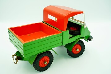 High-angle shot of a small toy truck model isolated on an empty white background