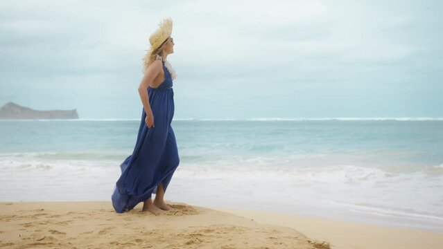 30s authentic traveler woman in purple maxi boho style dress enjoying view of Hawaiian beach. RED camera panorama shot around travel lady with lei flower neckless standing in scenic nature of Oahu 4K
