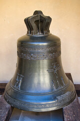 Bronze bell on the ground in Roztoky Castle. Czech Republic.