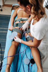 Fototapeta na wymiar Modern technology medical health and beauty treatment with electrostimulation EMS slimming machine.