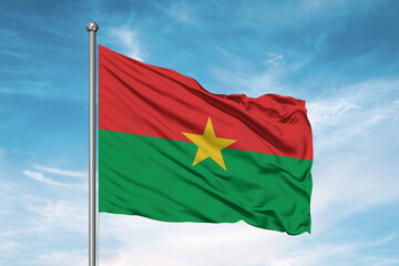 Fototapeta na wymiar Burkina Faso national flag cloth fabric waving on beautiful sky Background.
