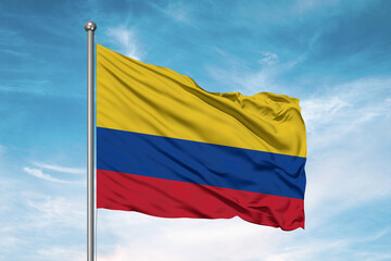 Colombia national flag cloth fabric waving on beautiful sky Background.