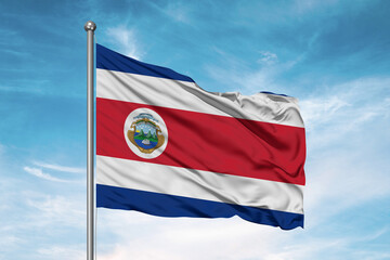Costa Rica national flag cloth fabric waving on beautiful sky Background.