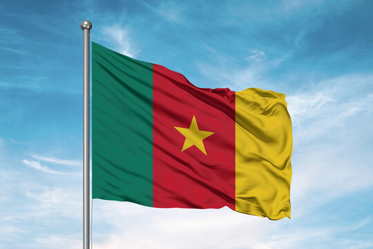 Cameroon national flag cloth fabric waving on beautiful sky Background. - Powered by Adobe