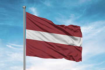 Latvia national flag cloth fabric waving on beautiful sky Background.
