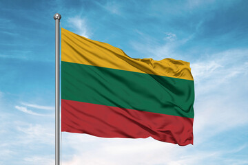 Fototapeta na wymiar Lithuania national flag cloth fabric waving on beautiful sky Background.