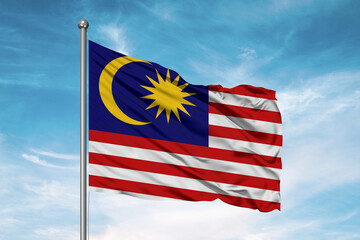 Malaysia national flag cloth fabric waving on beautiful sky Background.