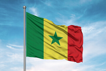 Senegal national flag cloth fabric waving on beautiful sky Background.