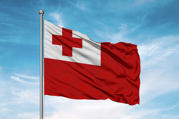 Tonga national flag cloth fabric waving on beautiful sky Background.