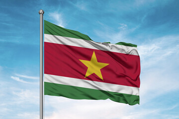 Fototapeta na wymiar Suriname national flag cloth fabric waving on beautiful sky Background.