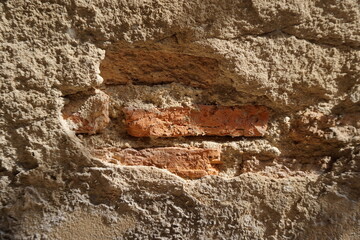 Close-up old wall cracked show brown brick. Grunge background for home improvement, house construction, home building, residential construction concept.