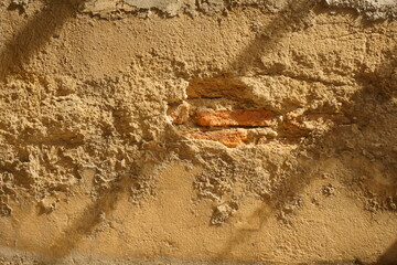 Old wall cracked show brown brick. Grunge background for home improvement, house construction, home building, residential construction concept.