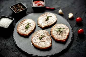 grilled pork steaks on stone background 