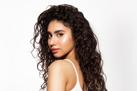 Young woman with beauty black curly hair with natural make-up and pure skin.