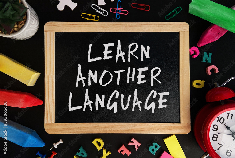 Aufkleber wooden board with learn another language text on a background of various colorful subjects