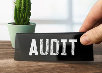 Text Audit writen on black table card