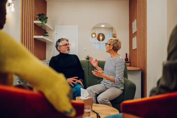 Senior people talking about their mental health on a group therapy session